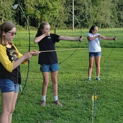 girl scouts practicing archery