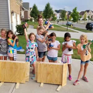 Daisy Scouts showing their power tools and assembled bat condos