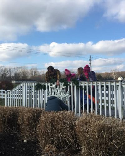 Girl Scouts decorating bridge for Winterfest