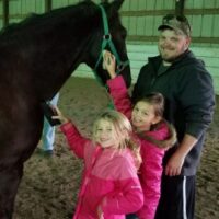 Daisy Scouts grooming a horse