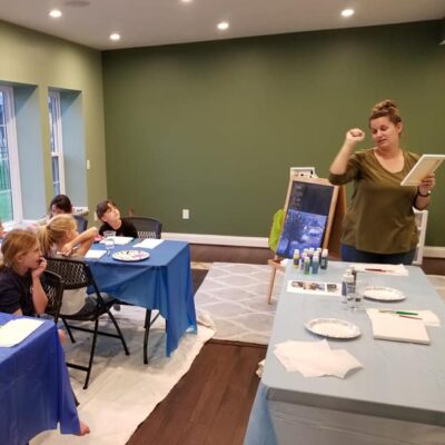 Brownies earning painting badge