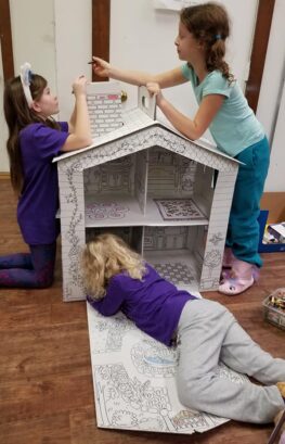 GIrl Scouts working together to color a house