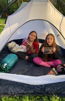 Girl Scouts with snacks in tent