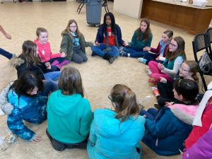 Girl Scouts singing in a circle